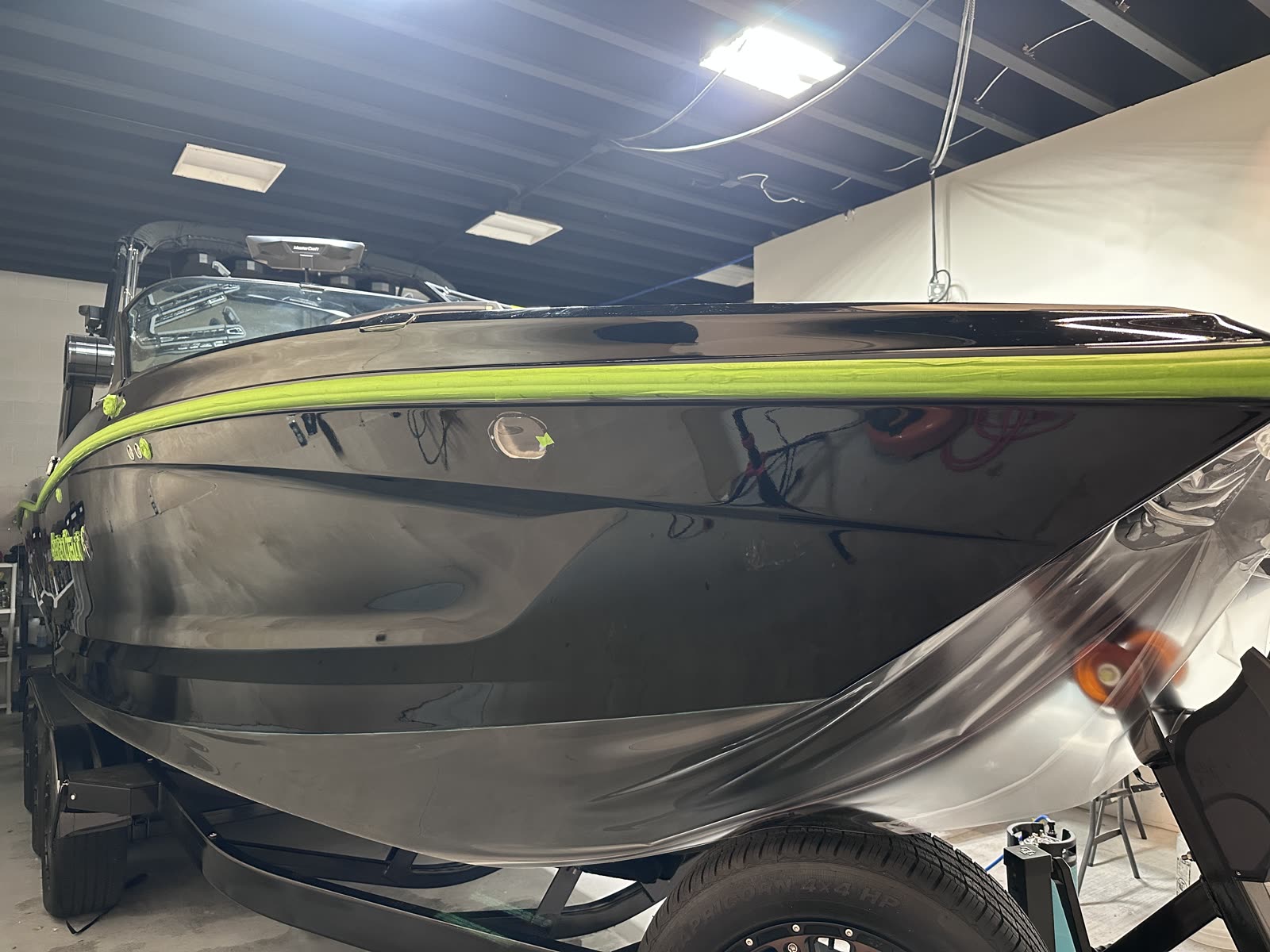 Yacht Armor marine protection film being installed on a MasterCraft hull side at our Utah shop